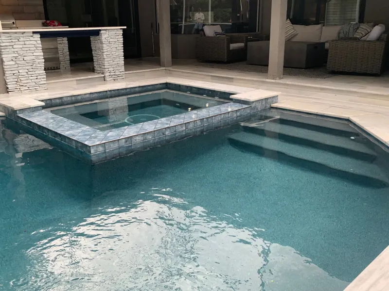 Spa addition with spillover water feature — Next Level Pools and Spas 3