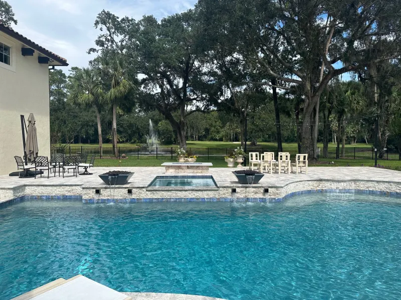 Spa addition with spillover water feature — Next Level Pools and Spas 5