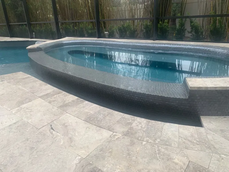 Spa addition with spillover water feature — Next Level Pools and Spas 7