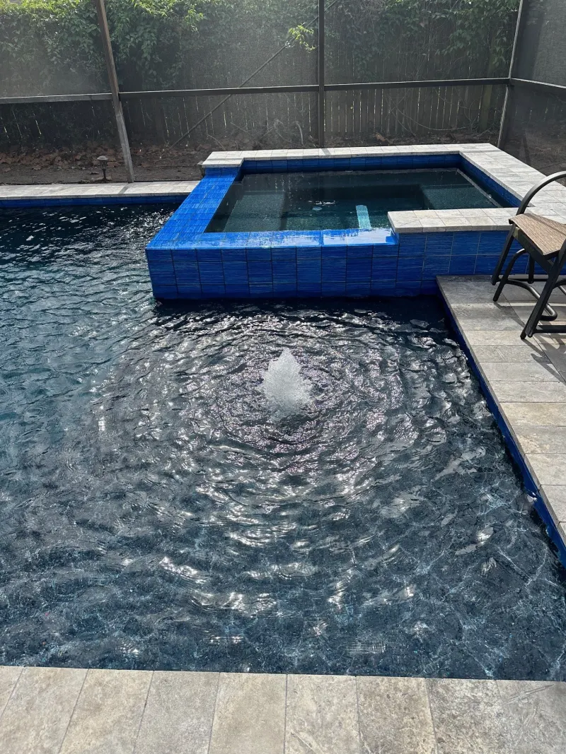 Spa addition with spillover water feature — Next Level Pools and Spas 8
